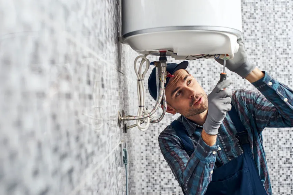 Plumber checking water heater
